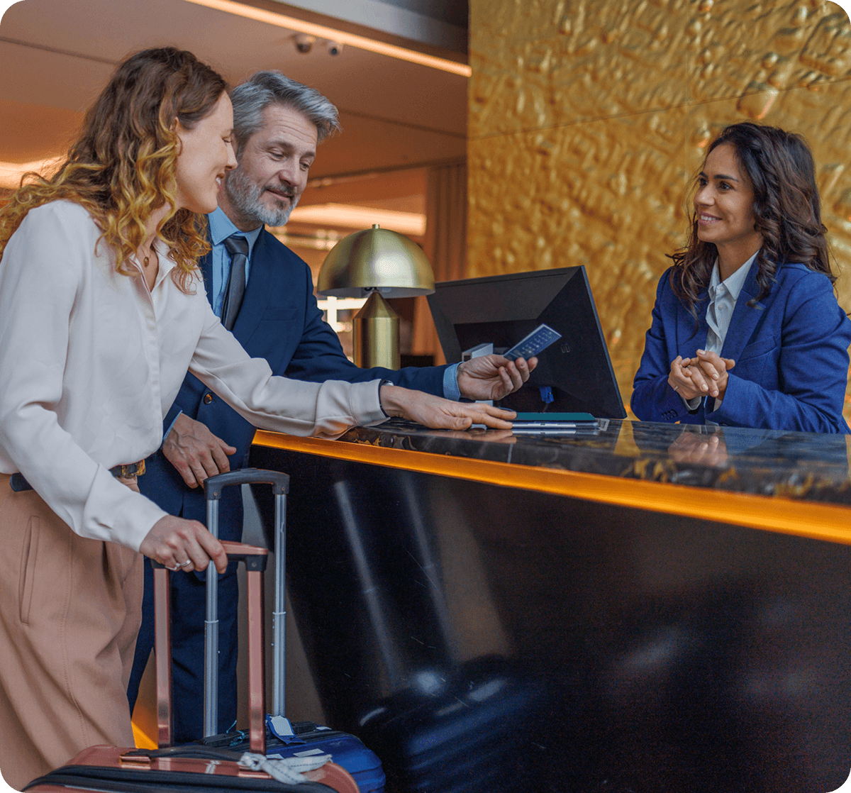Travelers at front desk with luggage