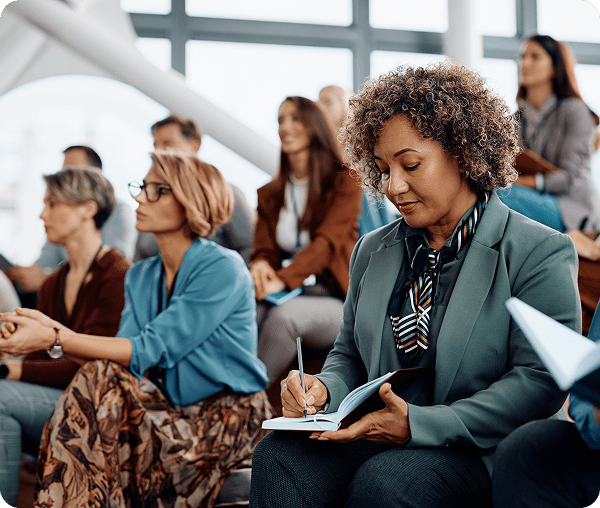 Woman taking notes in a seminar